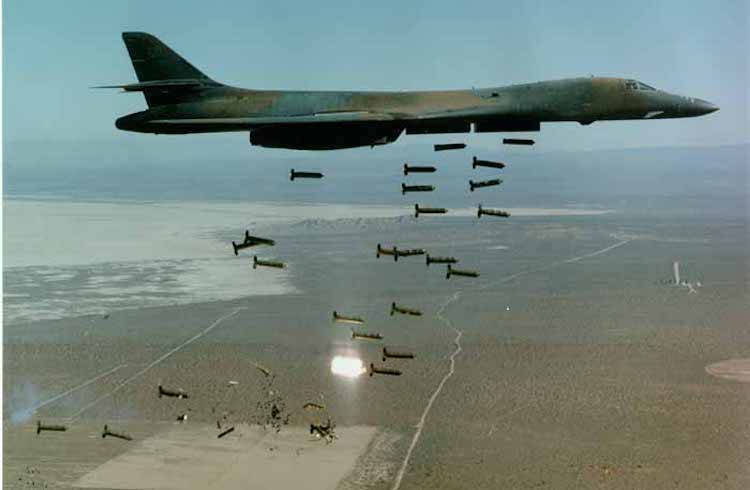 USAF B-1 Bomber dropping 30 CBUs (Cluster bombs). WikImedia Commons.
