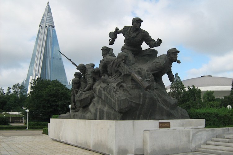 Photo: The Korean War Memorial in Pyongyang, North Korea, with the pyramidal Ryugyong Hotel in the background. C BY-SA 3.0