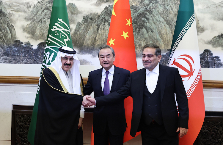 Wang Yi (center), a member of the Political Bureau of the Communist Party of China Central Committee and director of the Office of the Central Foreign Affairs Commission, with representatives from Saudi Arabia and Iran in Beijing. [Photo by Wang Jing / China Daily]